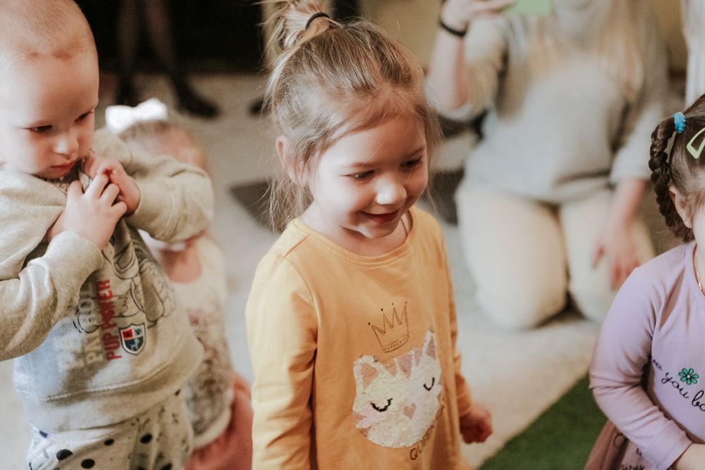 Happy young children playing with toys at daycare